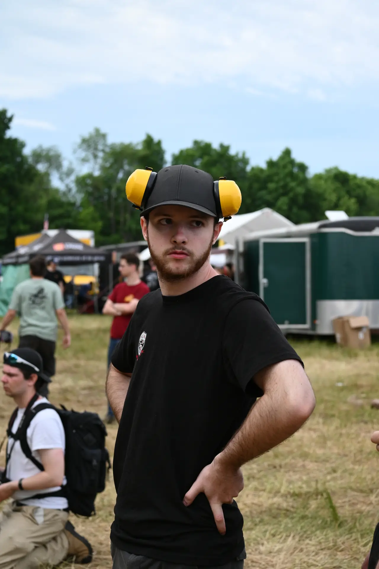 Team member in the paddock wearing ear protection