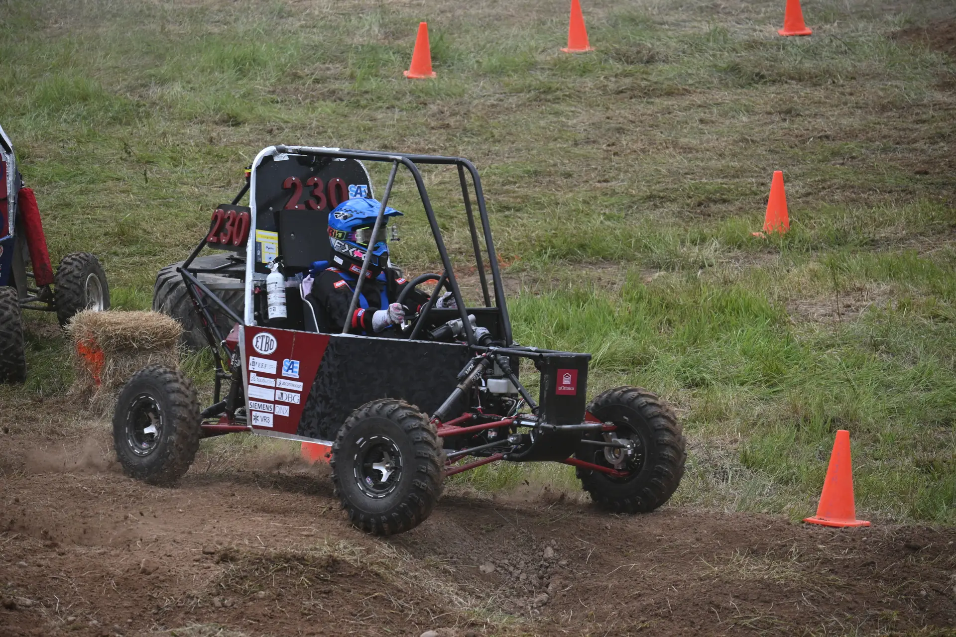 Car #230 turning between cones