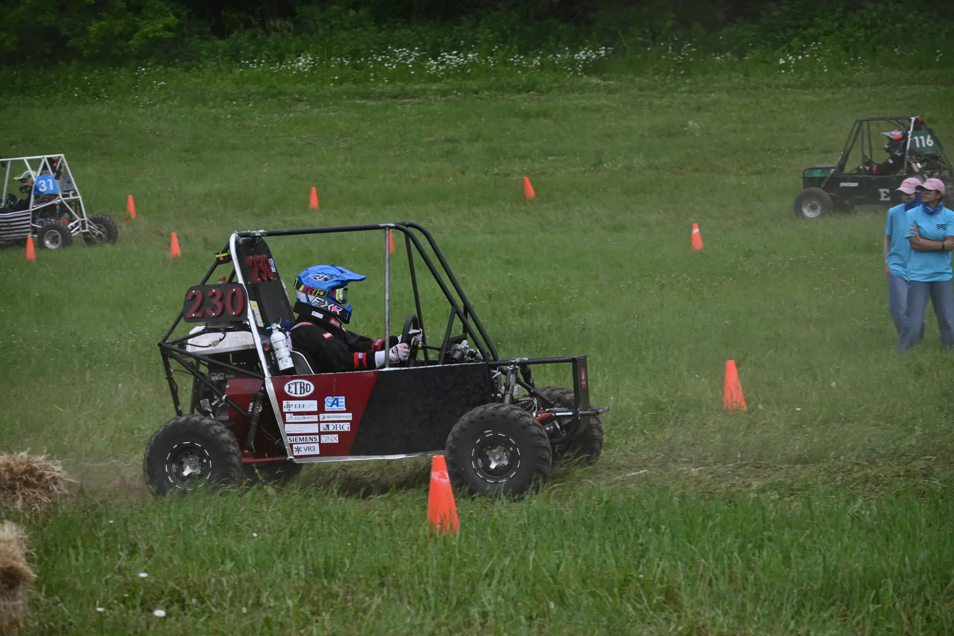 Car #230 cornering on grass
