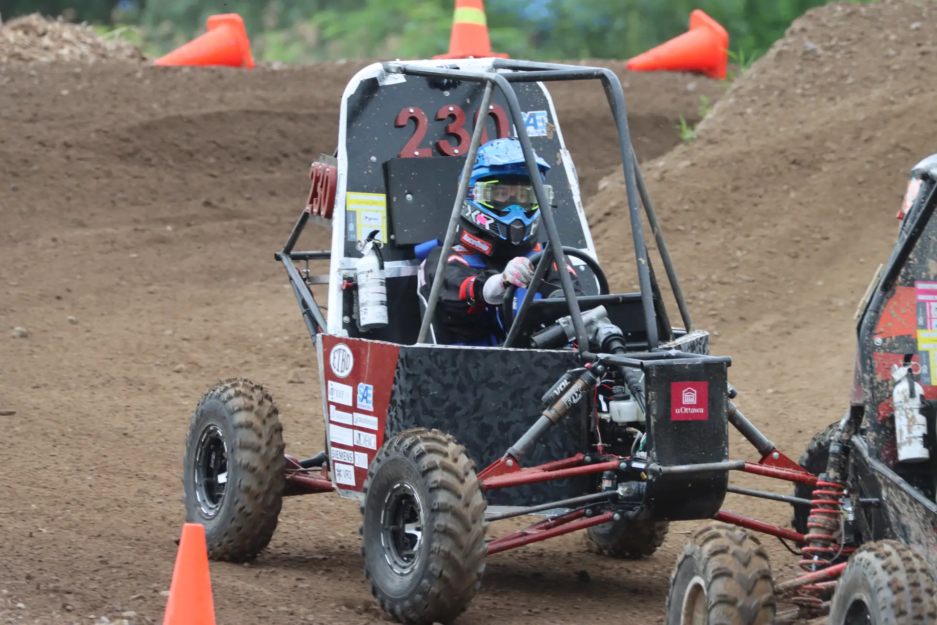 Front view of car #230 on course, showing the front suspension