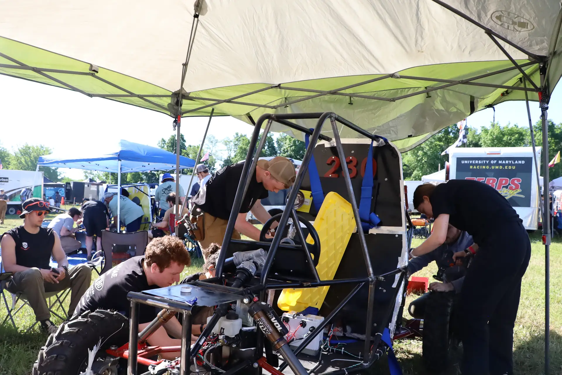 Team members working on the car in the paddock