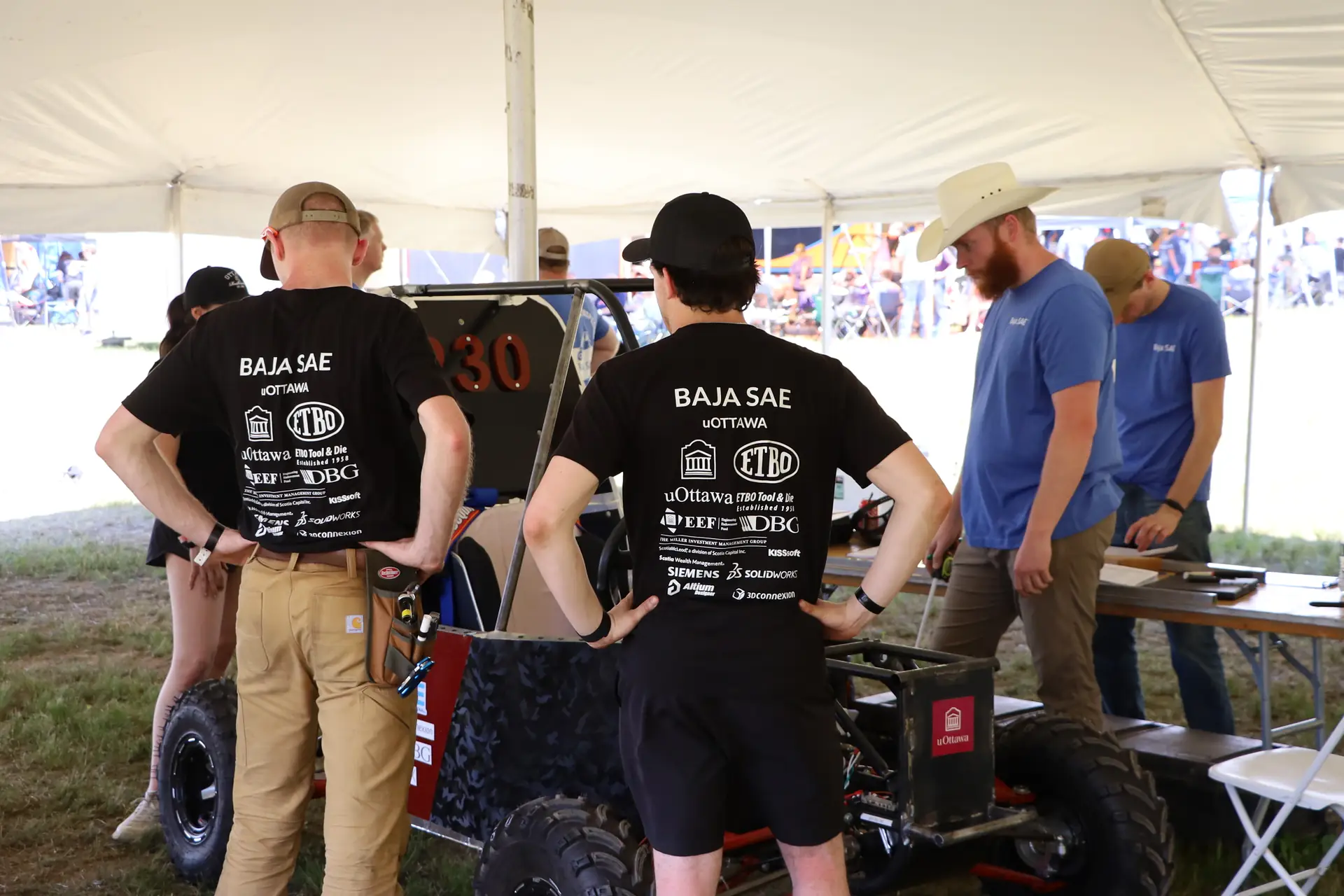 Team members at technical inspection with SAE officials