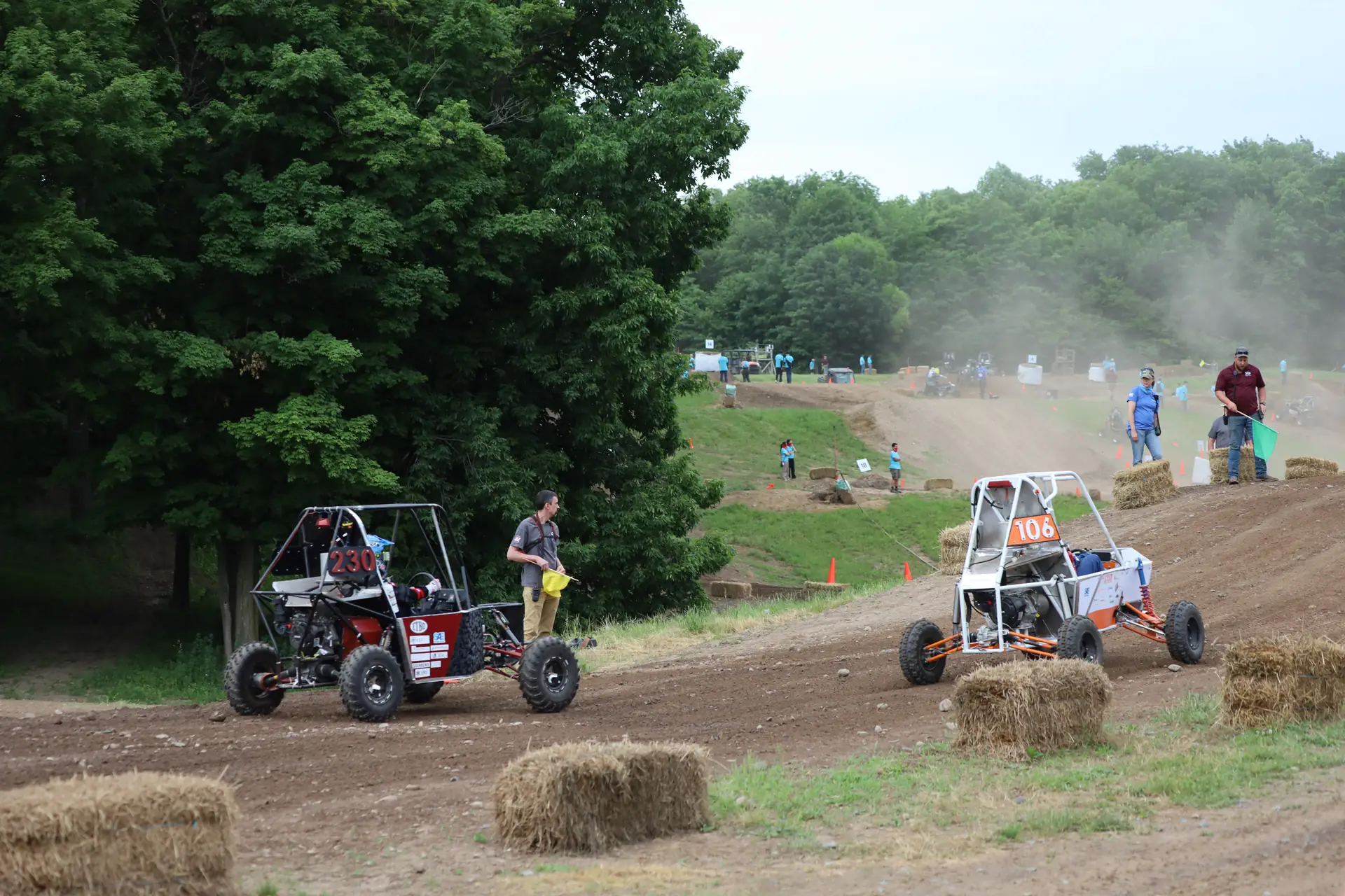 Cars racing on the endurance course with dust in the air