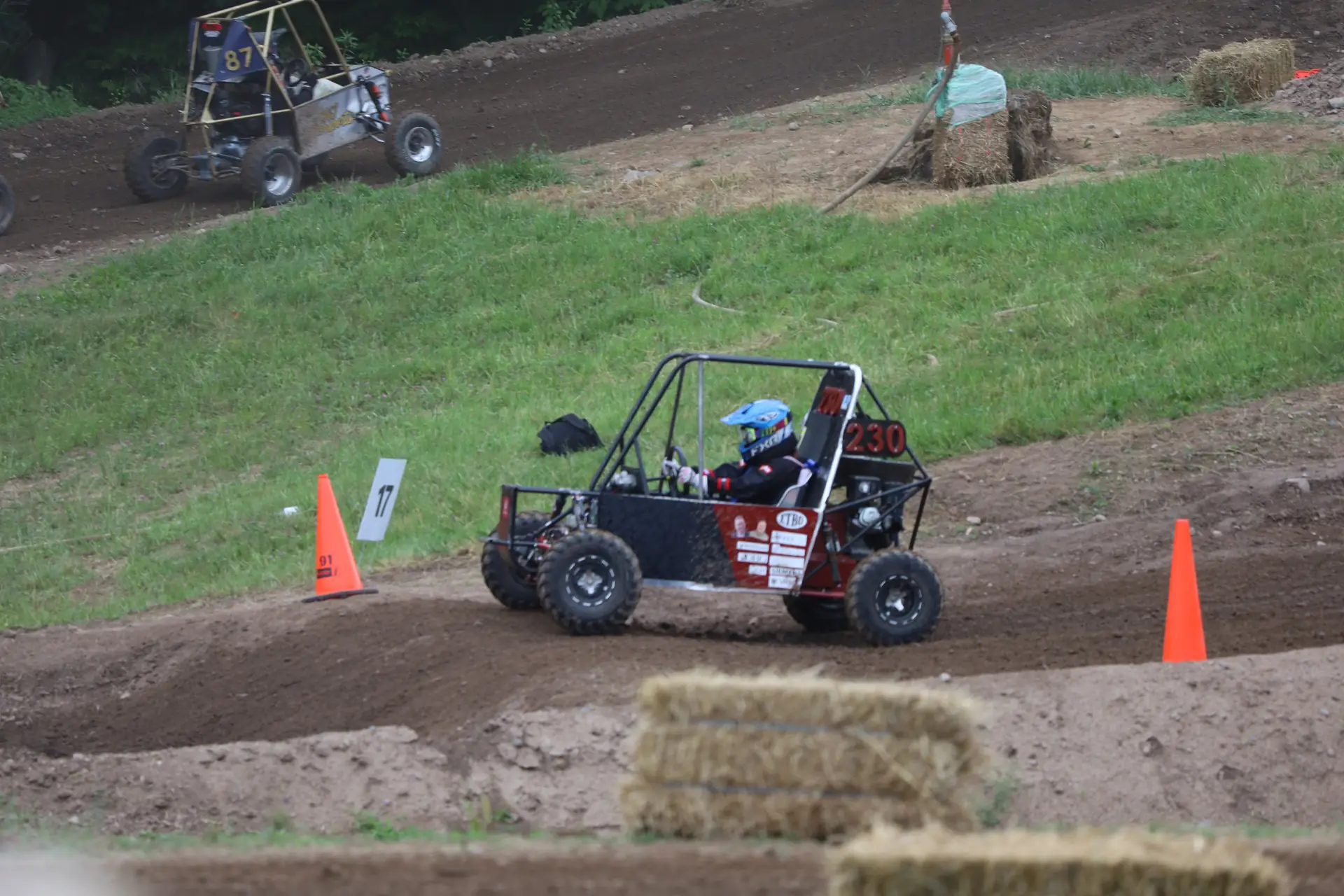 Car #230 through a turn beside cones