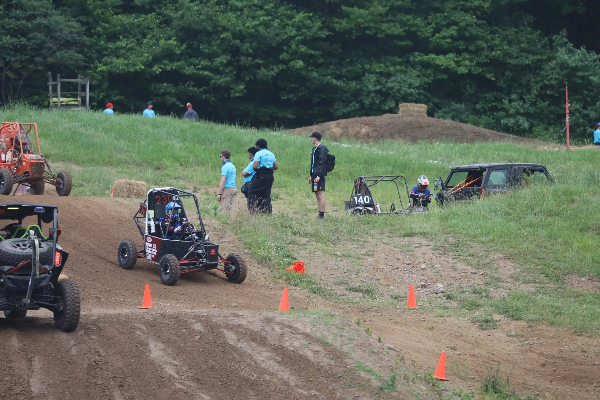 Car #230 on course with spectators behind