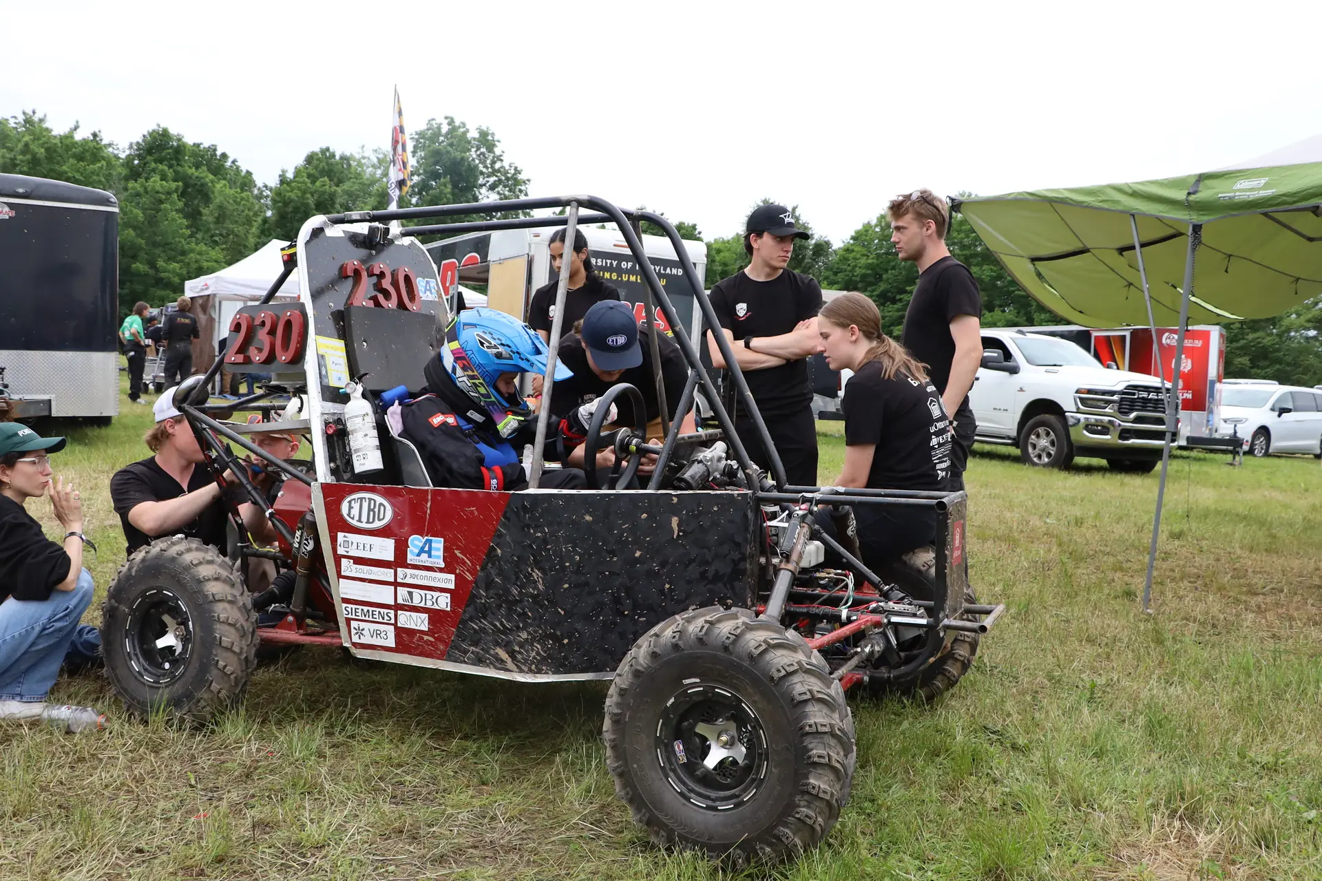 Team members working on the car in the paddock